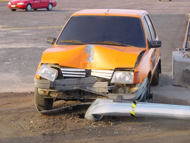The orange test car with the pole under its front and the yellow and black test marking.